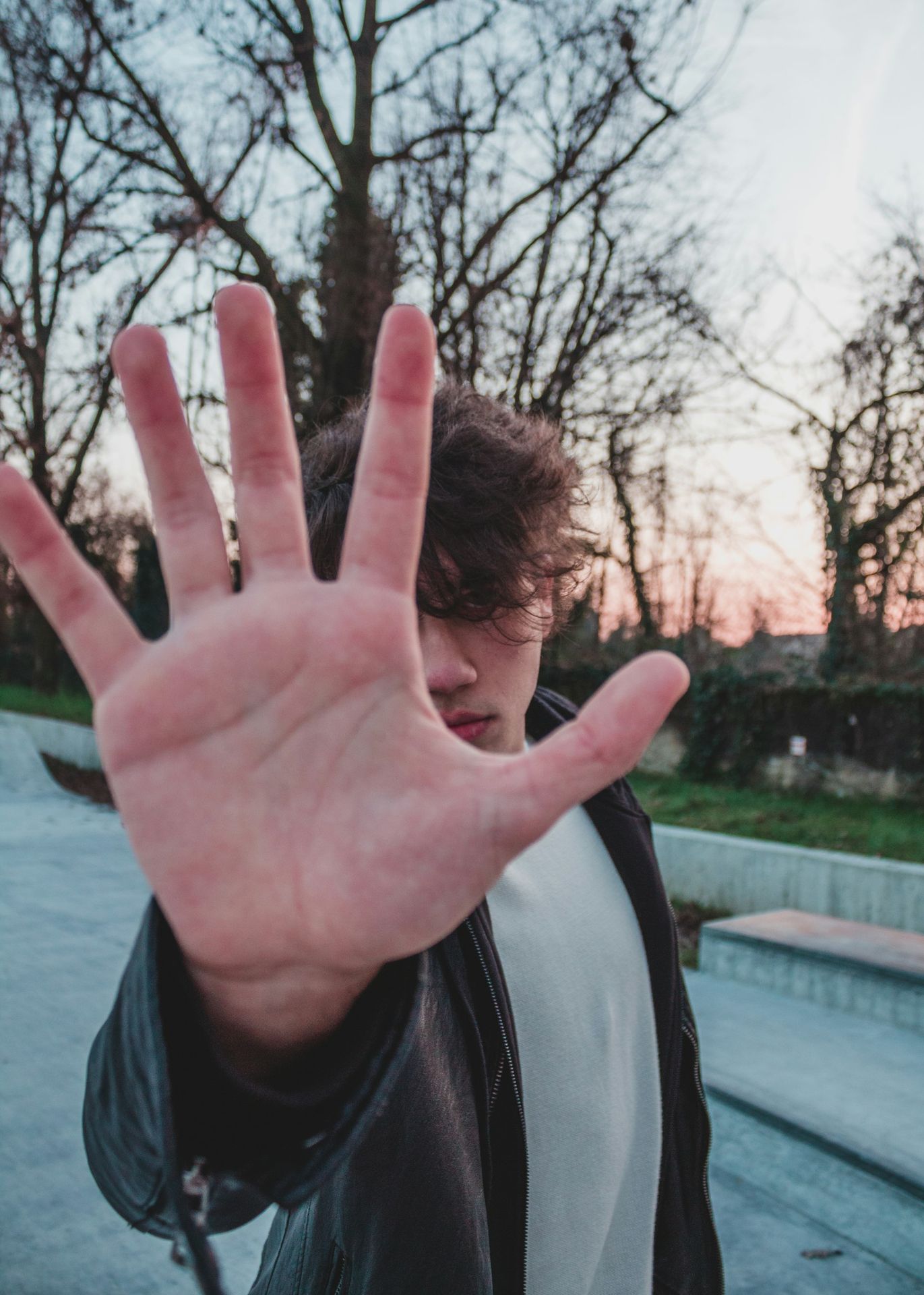 person in black and white jacket showing left palm